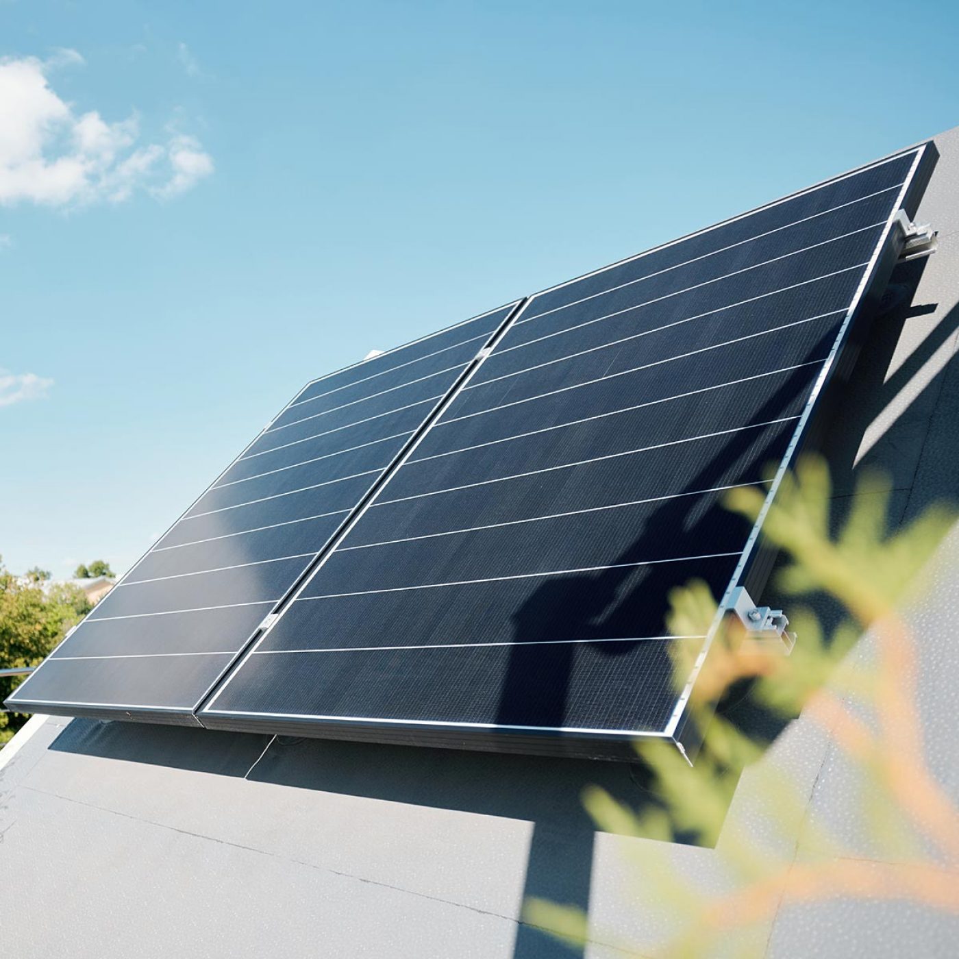 Large solar panels on rooftop of modern comfortable house or cottage in natural environment